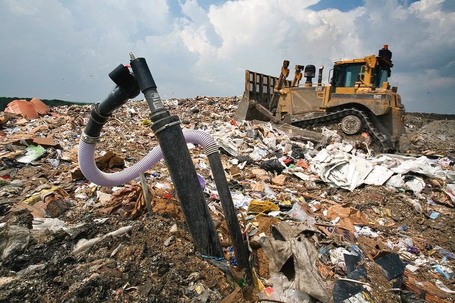 Landfill gas wellhead at a working face — the kind of obstacle that causes costly strikes when heavy equipment can't see them through fog or waste